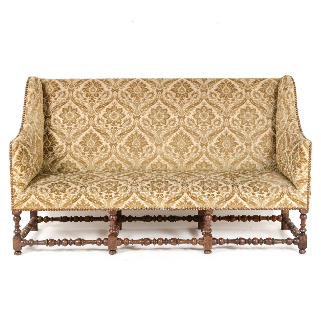 Rare French antique Louis XIII sofa, circa 1630 with turned stretchers and high back. This sofa is structurally sound and is in remarkable condition considering is age. Upholstery is in good condition with individual hammerhead nails.