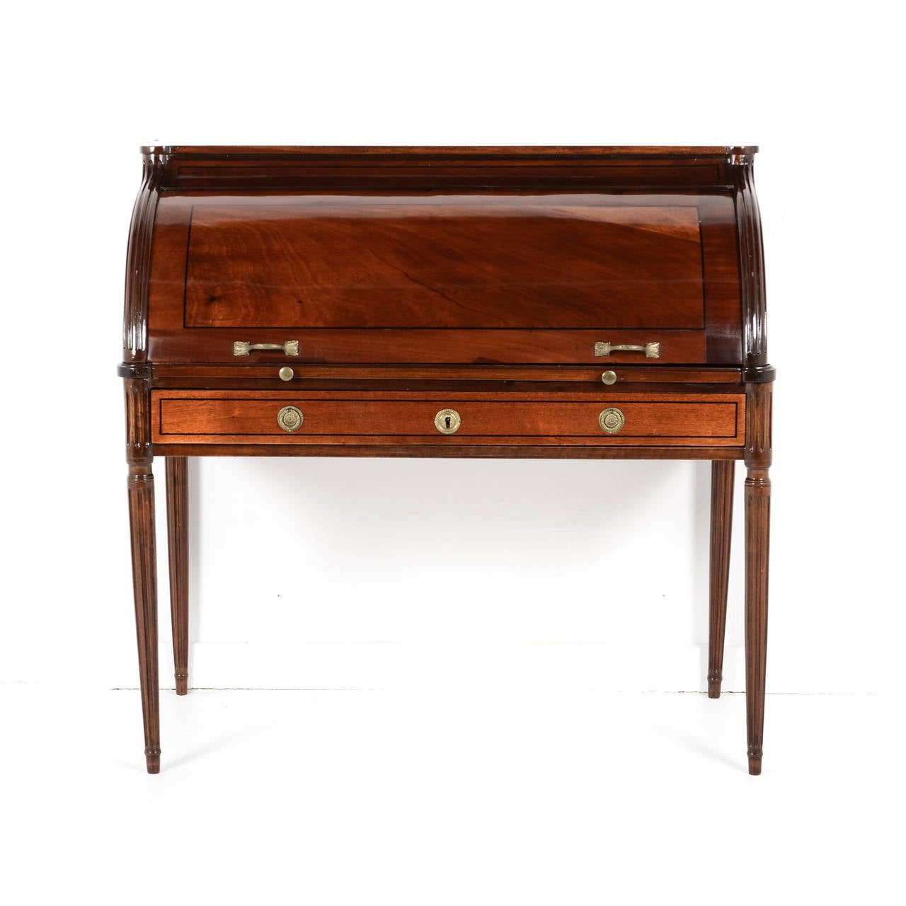 An elegant French antique cylinder desk from the 19th century. In superior original condition with ebonized pin stripe detail and beautifully cast bronze mounts and pulls. French polish.