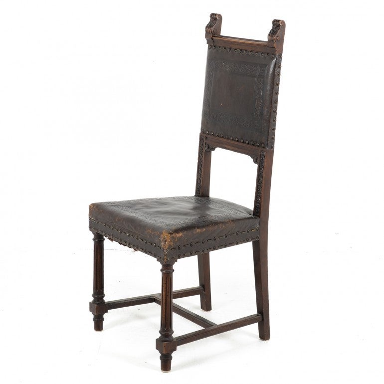 A rare find. An unusually large scaled complete set of twelve original hand tooled leather seats French antique dining chairs in the Henri II style all in excellent original condition. The leather is still very good on all chairs with minor