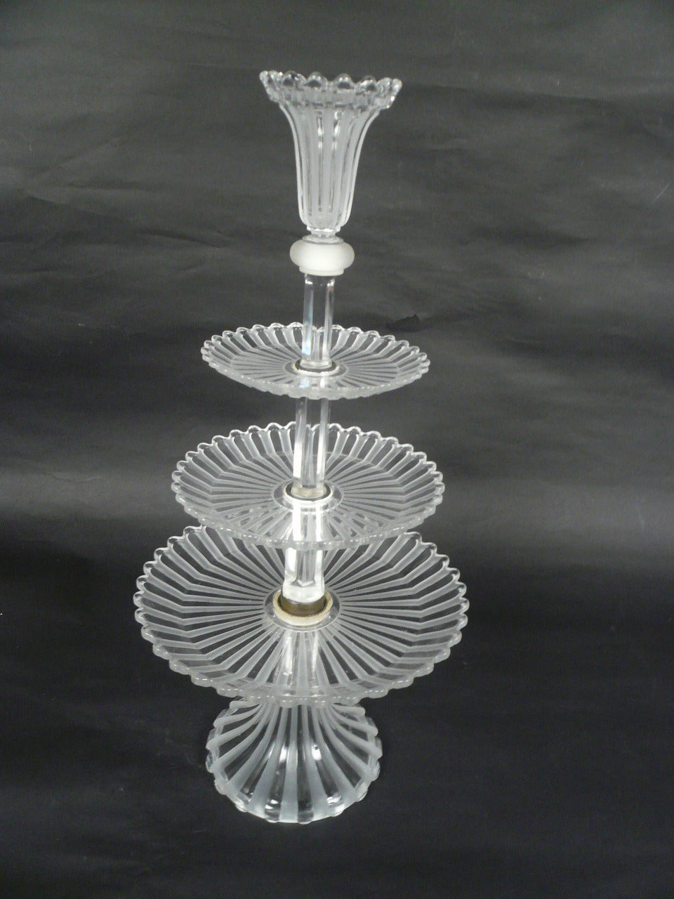A signed Baccarat moulded, and frosted glass three tiered pastry stand.
The three graduated tiers are surmounted by a 4