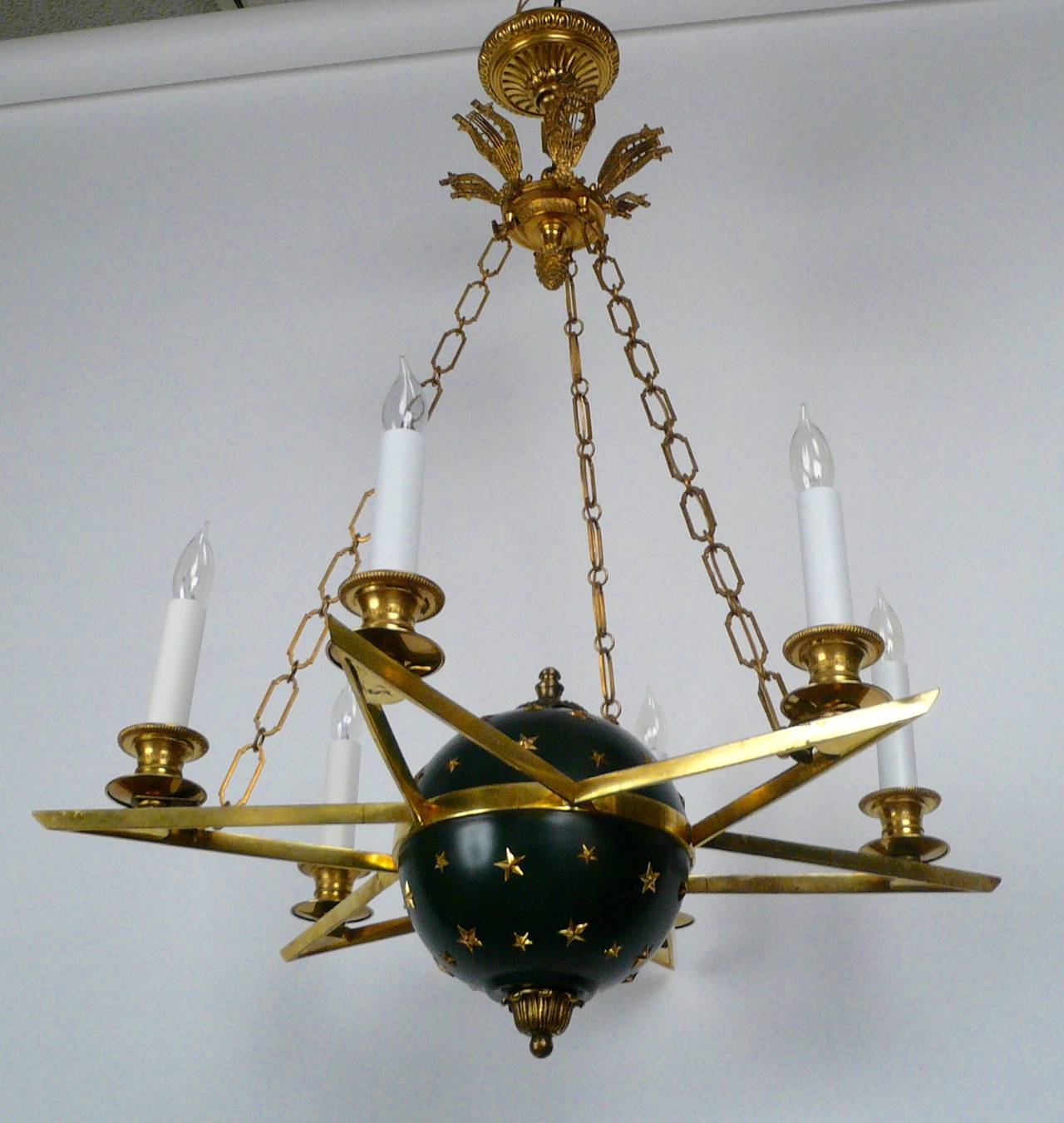 This patinated and gilt bronze six-light Empire style chandelier with celestial motifs, is by the pre-eminent American maker, Edward F. Caldwell.