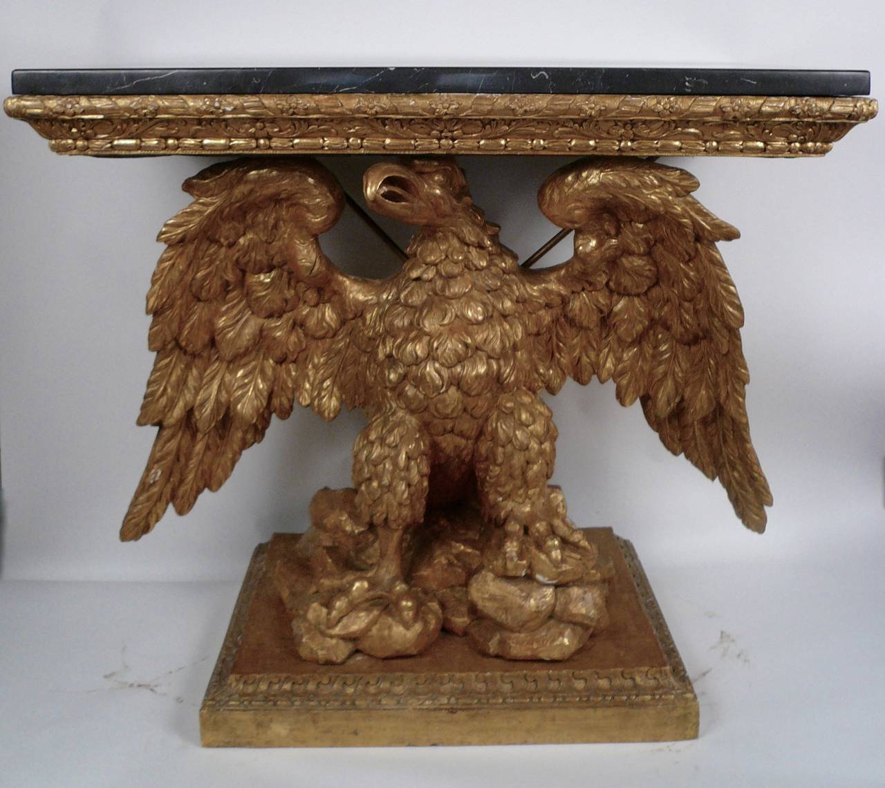 This important pair of mirror image, carved and giltwood marble top consoles in the manner of William Kent, were purchased in the 1980s from a leading London dealer to grace the entrance hall of 