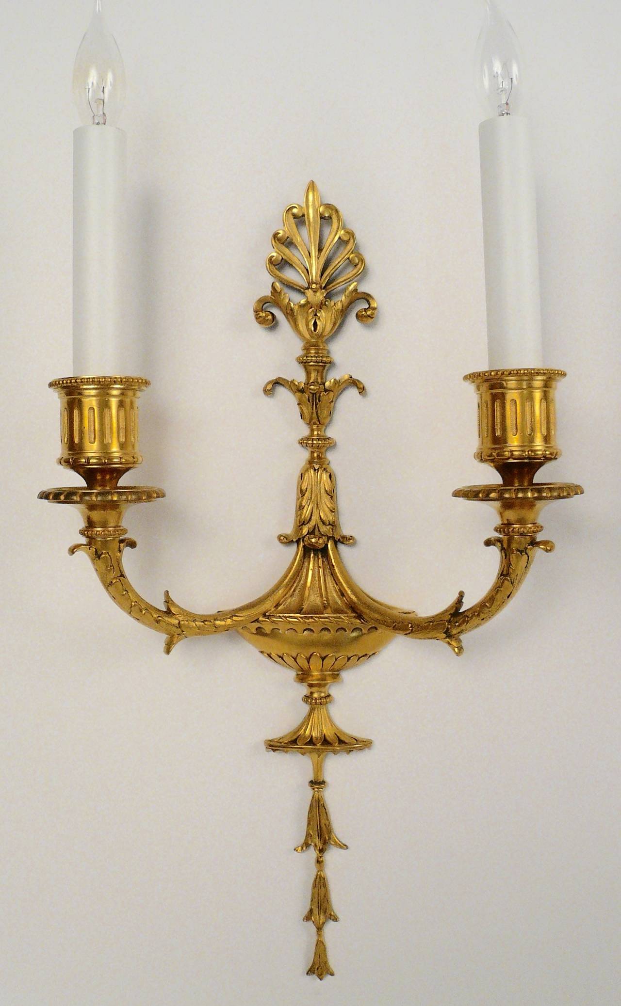 These urn form sconces with hanging bellflowers topped with anthemion, have their original gilt finish.