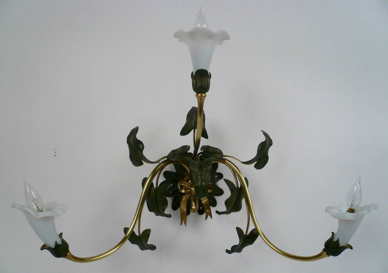 Originally gas powered, these three-light sconces have well detailed naturalistic leaves and flowers.
