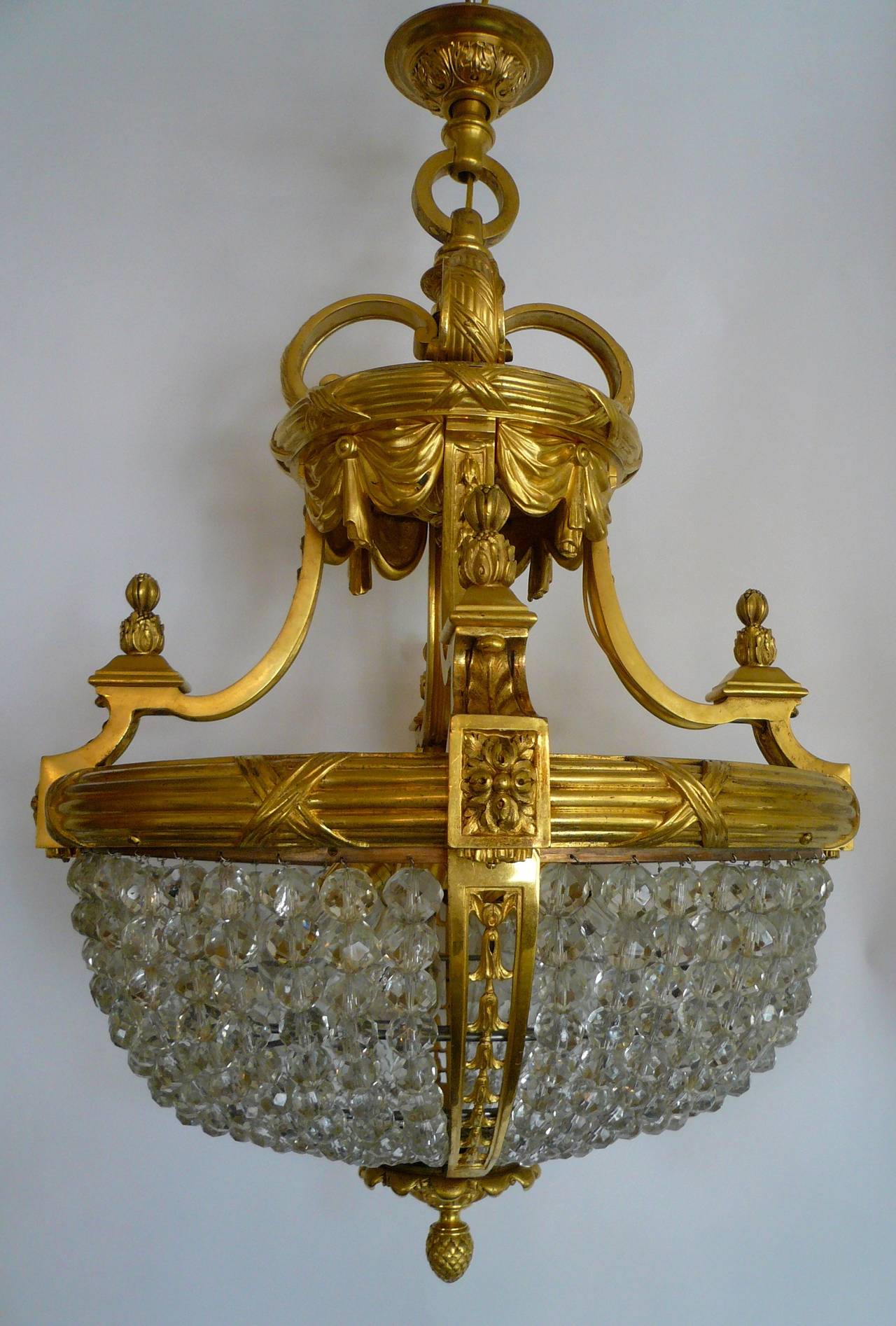 With great detail and finish, this gilt bronze fixture by Edward F. Caldwell is strung with faceted crystal beads, and has six lights.