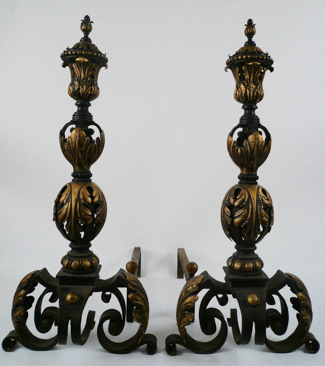 Impressive pair of very heavy gauge wrought iron andirons of baronial proportion.