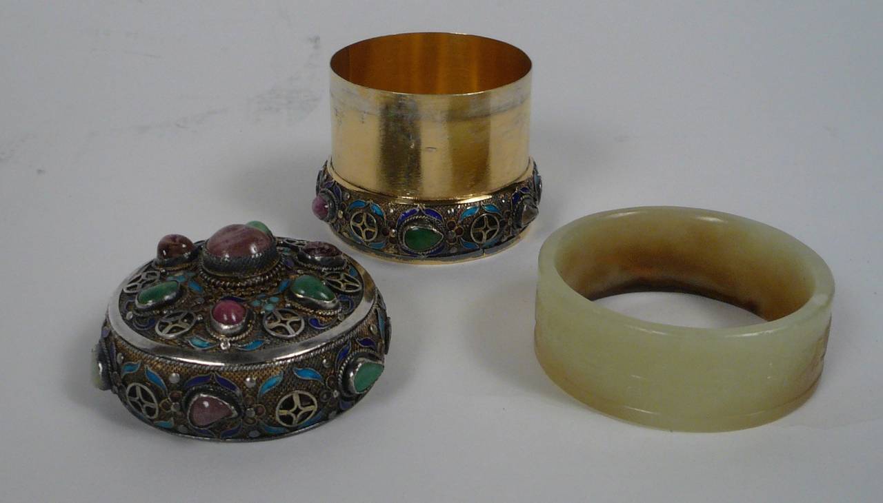 This early 20th Century enameled silver box set with semiprecious stones is complimented by a removable carved jade 