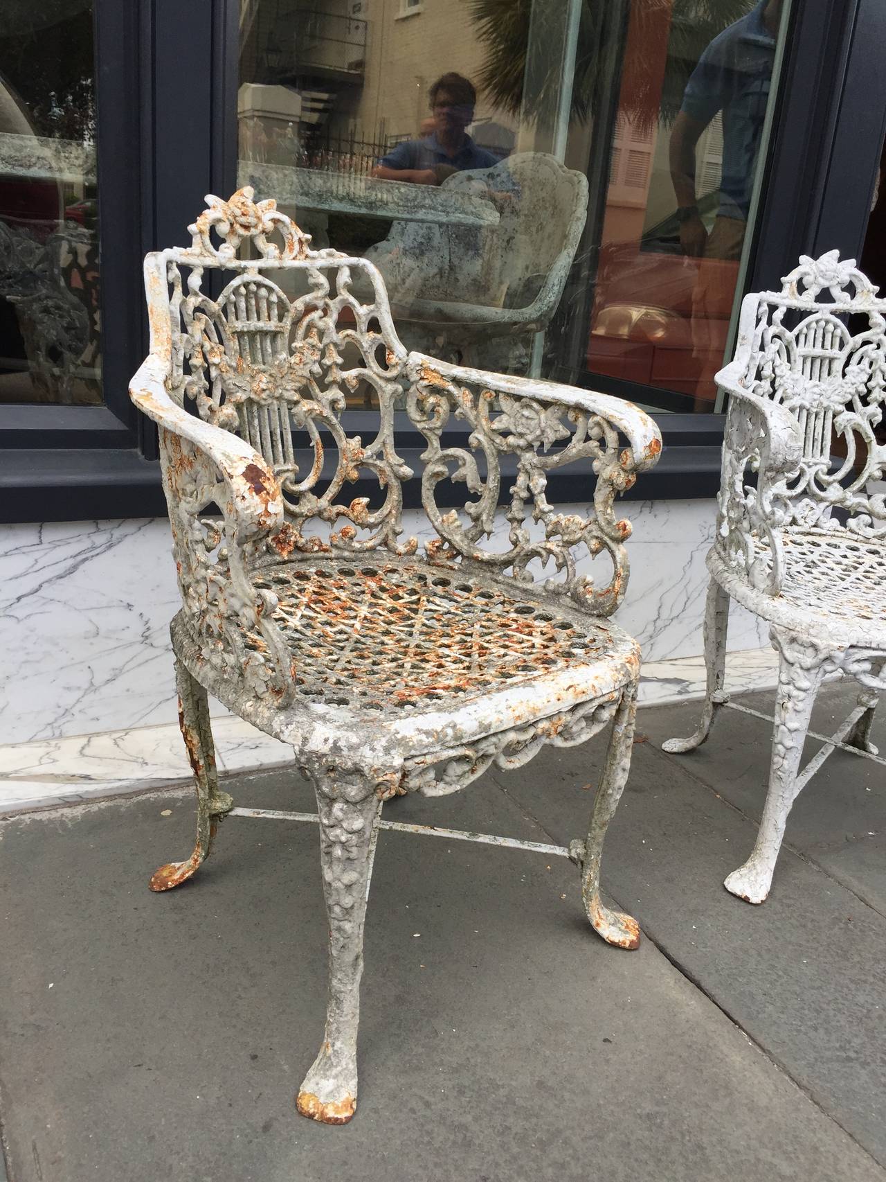 pair of English cast iron garden arm chairs late 19th century