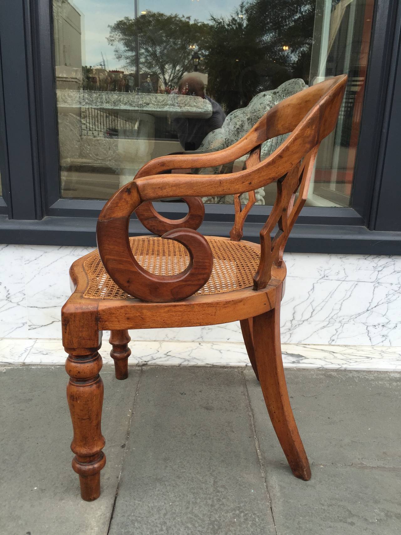 English walnut arm chair with cane seat bottom and turned legs