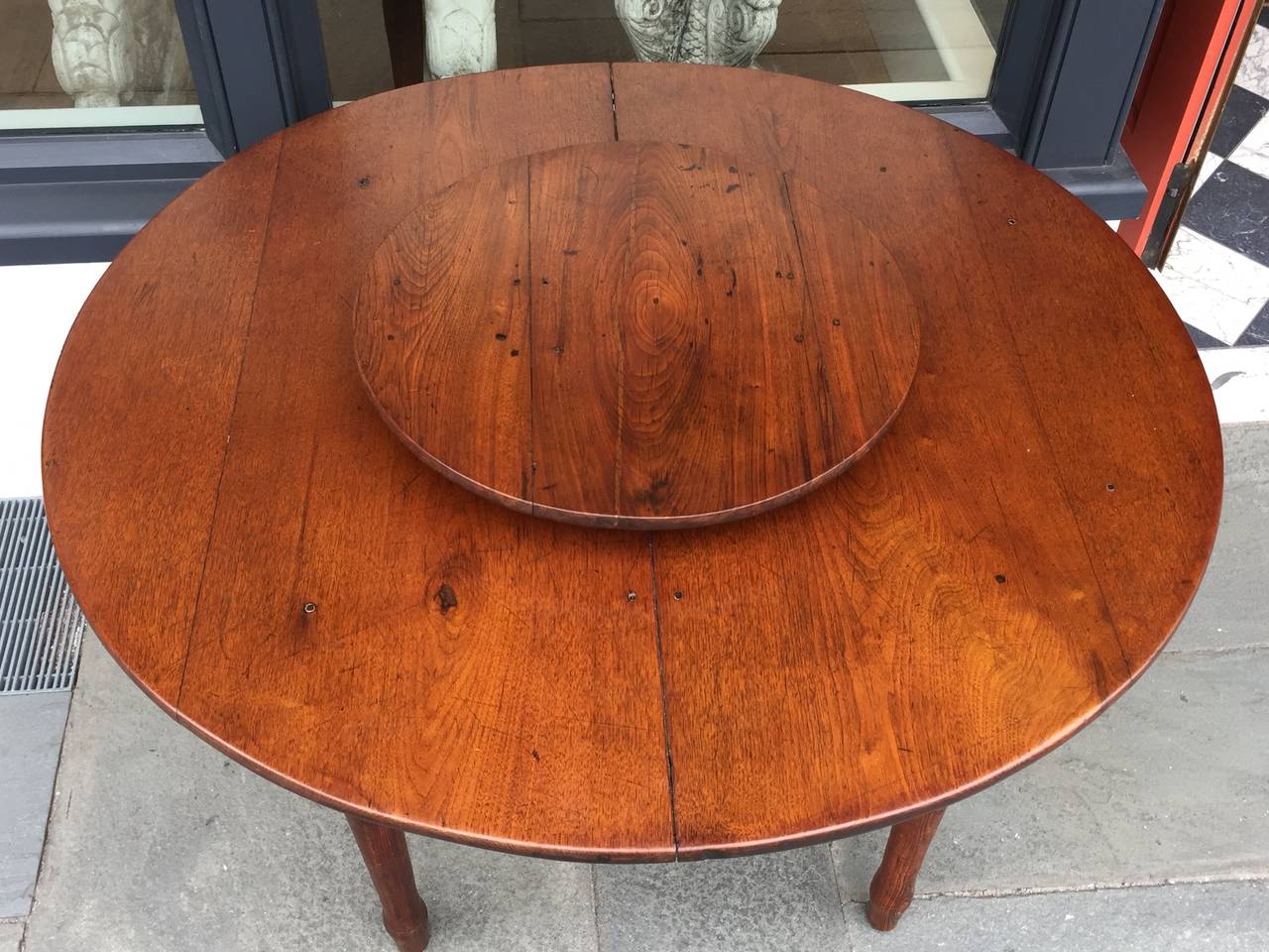 American round dining table with lazy susan mechanism in middle.
Walnut and yellow pine.