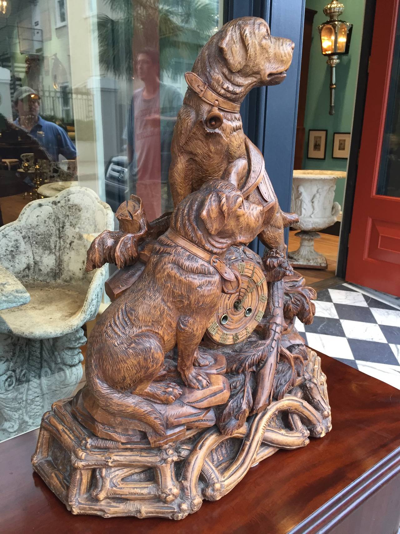 Very nicely carved Black Forest dog clock with 8 day strike and time movement. Nice lighte color gives clock a very warm feel. Movement was recently serviced with warranty.