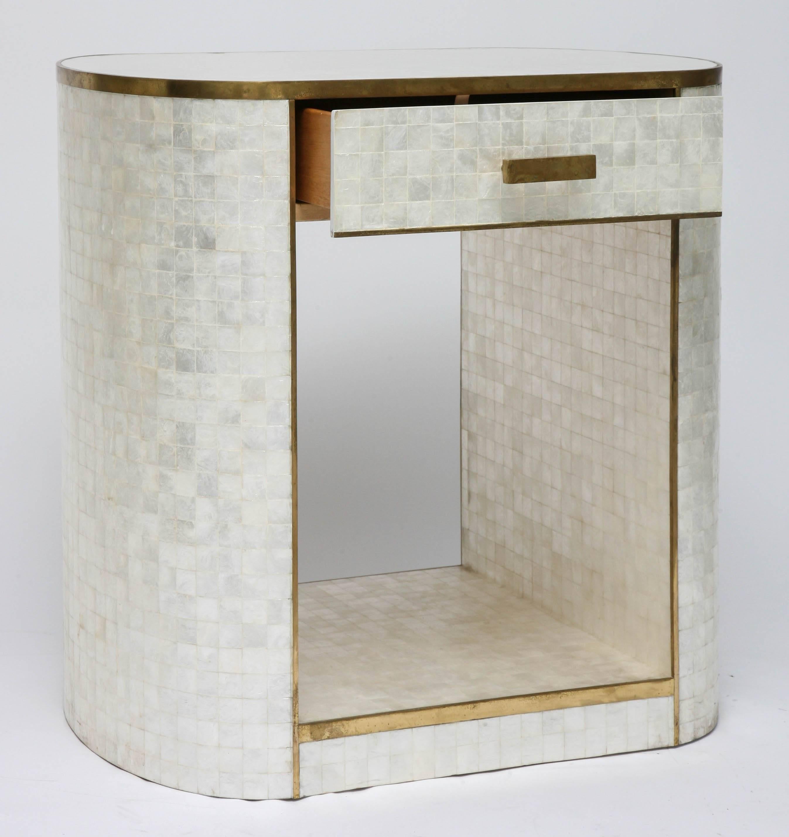This stylish and chic piece was created by the Platt Collections, and iit s fabricated in capiz shell with antique-finished brass trim. The piece has the versatility to be a bedside table, entry hall chest or perhaps a dressing-vanity table. 

 