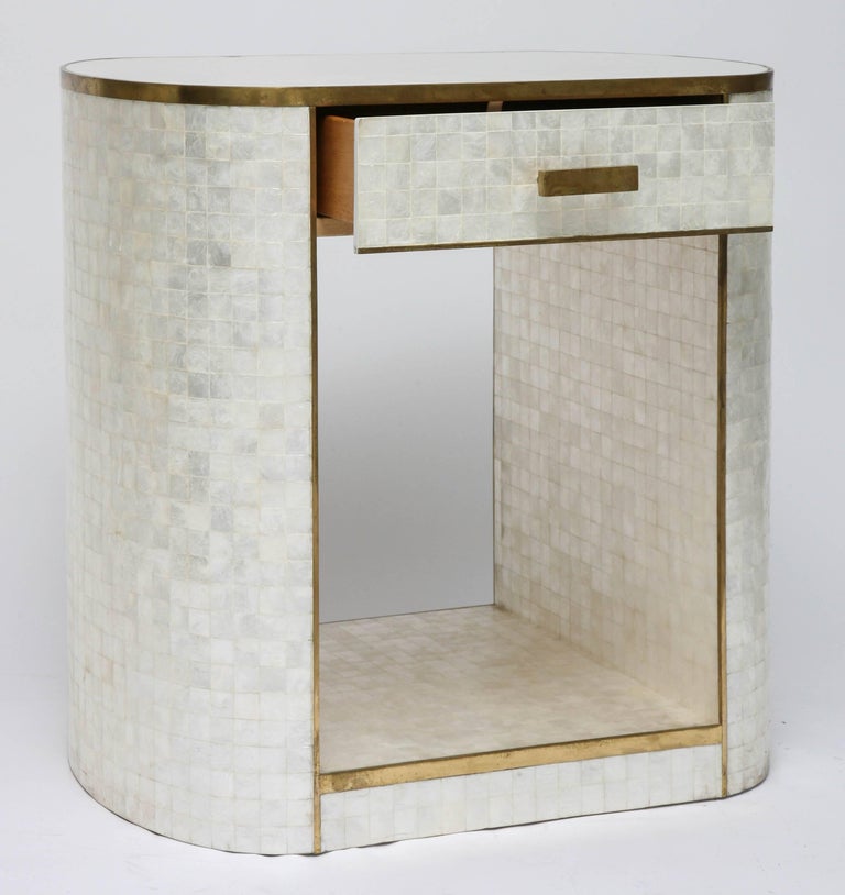 This beautify and stylish piece was created by the Platt Collections and is fabricated in capiz shell with antique-finished brass trim. The piece has the versatility to be a bedside table, entry hall chest or perhaps a dressing-vanity table. 

 