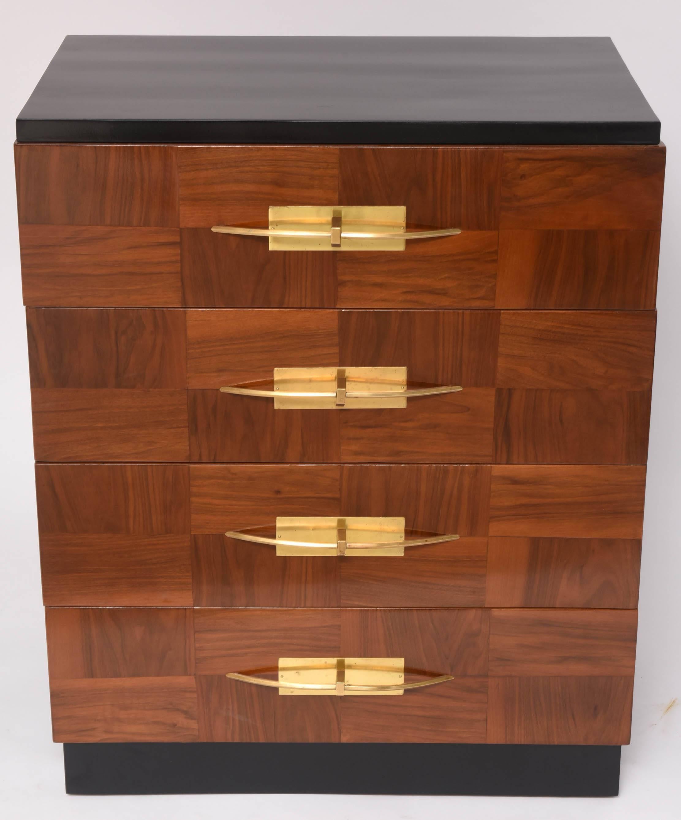 This stylish four-drawer chest dates from the early 1940s and has been professionally restored. The drawers are veneered in a patch-work pattern with polished brass handles. The sides and top are lacquered black as is the toe-kick space.

    