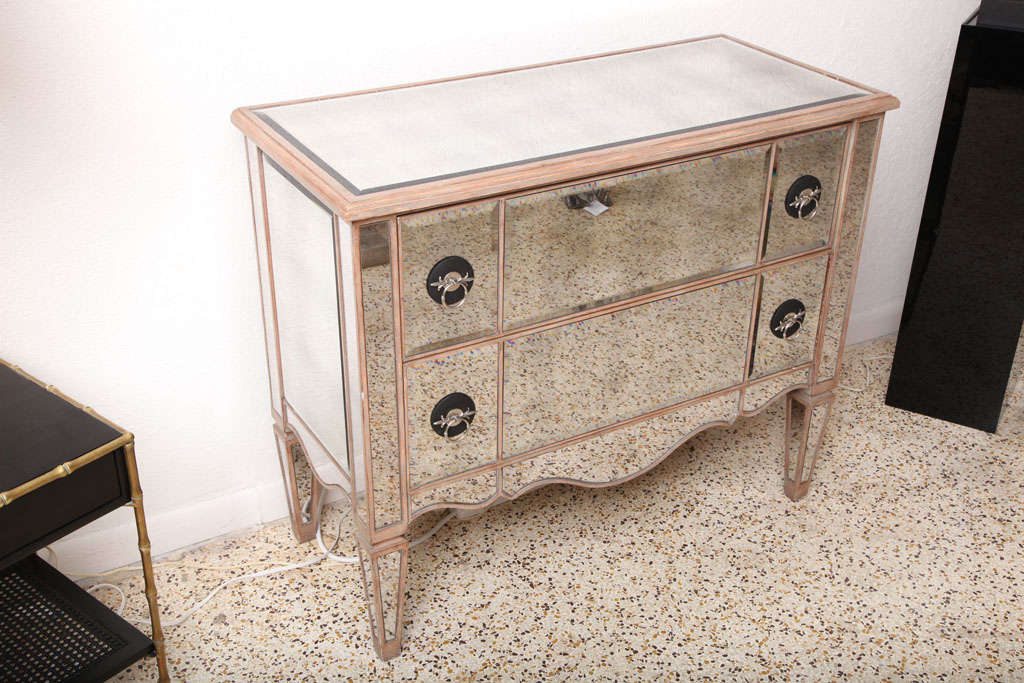 This stylish and chic Louis XVI style chest of drawers dates to the 1980s-1990s and is very much in the style of pieces created by Dorothy Draper and Syrie Maugham.

Note: The speckles you see in the mirror is the terrazzo stone floor.

