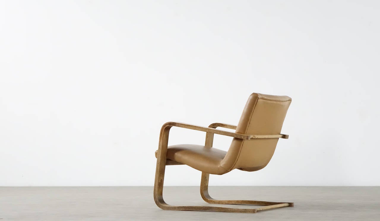 This bentwood cantilever easychair was designed in the 1950s in the style of Alvar Aalto. The chair features a bent base made from elm-faced plywood with a faux-leather seat - it is ultracomfortable! for its age the chair remains in a good vintage