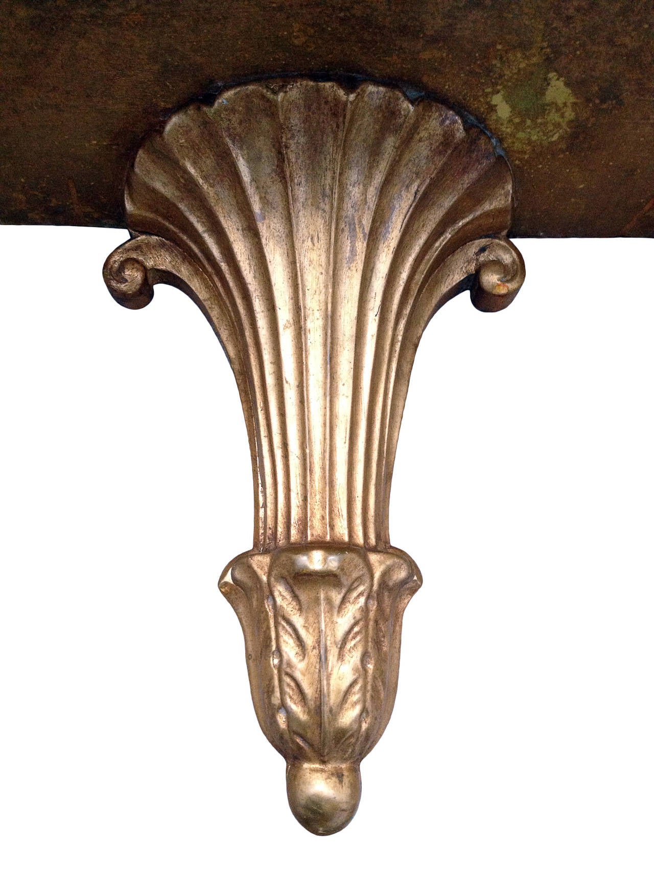 A very decorative pair of 1940s Regency style wall brackets made of carved and gilt wood.The height of one bracket has been adapted on the underside to match the height of its counterpart.