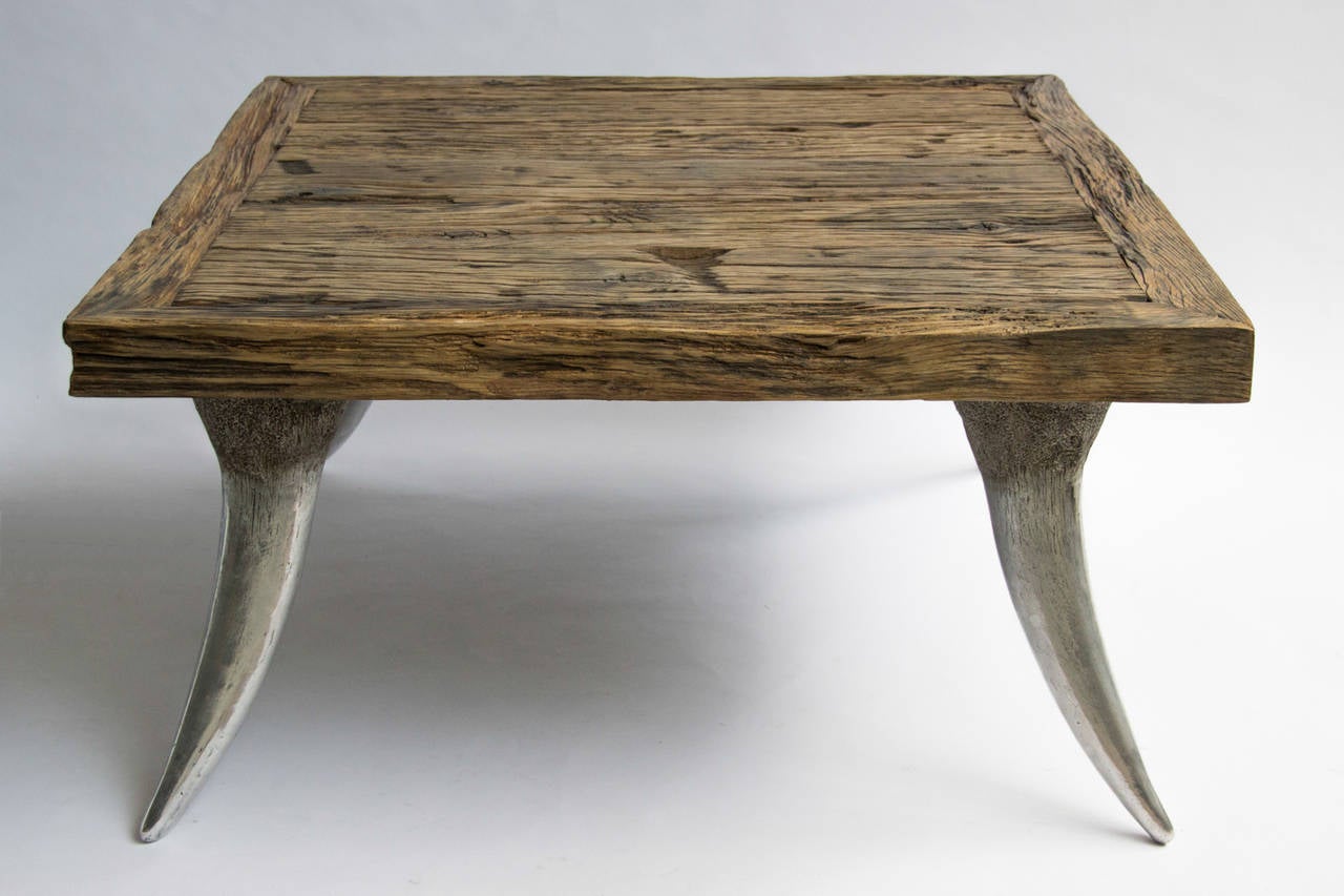This table is made of patinated aluminium and antique French oak. The legs are casts of exact replicas of the original horns.

Dutch artist Raymond Spier cast his own design during over 40 years, mostly in bronze. Using the ancient lost-wax