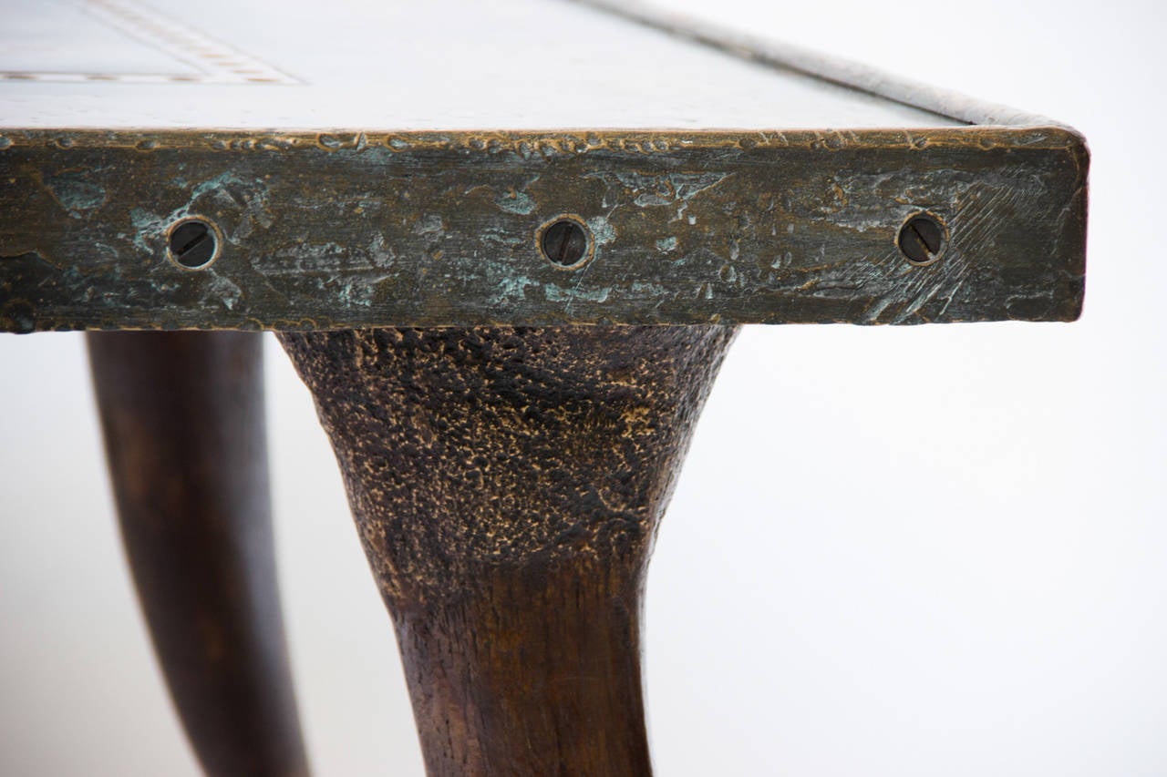 This table is made of wood, patinated bronze and copperplate. The legs are casts of exact replicas of the original horns.

Dutch artist Raymond Spier cast his own design during over 40 years, mostly in bronze. Using the ancient lost-wax technique