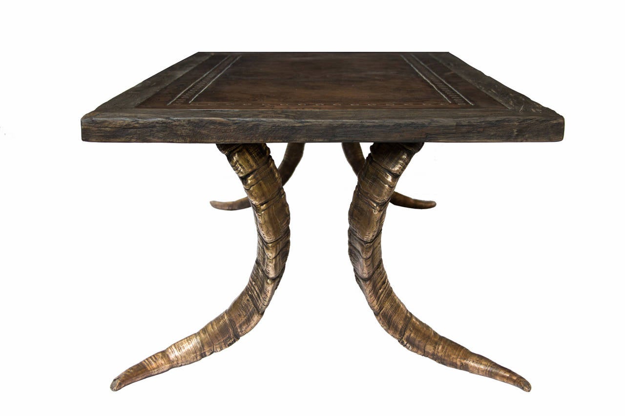 This table is made of patinated bronze and copper and antique French oak. The legs are casts of exact replicas of the original horns.

Dutch artist Raymond Spier cast his own design during over 40 years, mostly in bronze. Using the ancient
