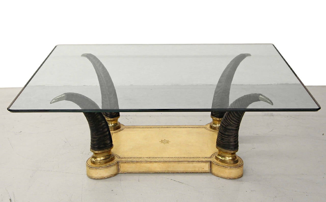 Very designer faux horn coffee table on embossed leather base with chrome details.  Similar in style to Maitland Smith.

Measurements are with glass.