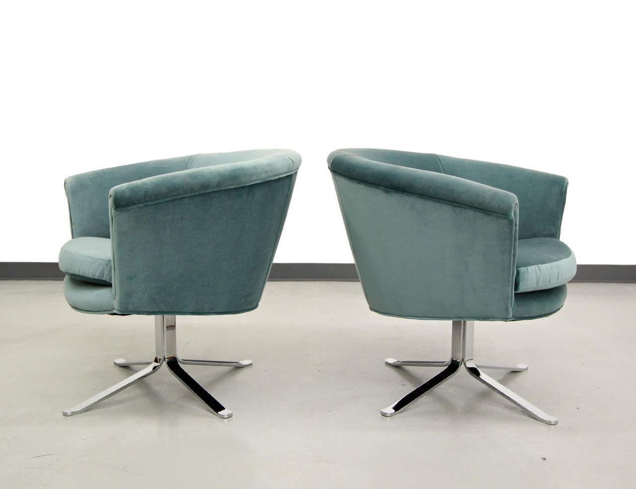 Beautiful pair of seafoam velvet swivel chairs with mint condition chrome bases attributed to Nicos Zographos.