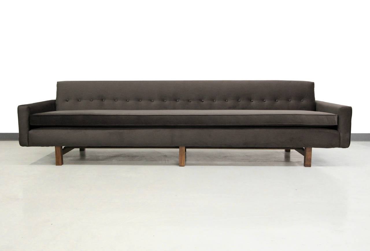 Absolutely amazing 9.5ft Mid-Century sofa. This sofa is sleek, modern and Classic with tons of seating and style to mesh with most any decor. Beautiful charcoal fabric contrasts beautifully with the solid walnut legs. Although unmarked, sofa is very