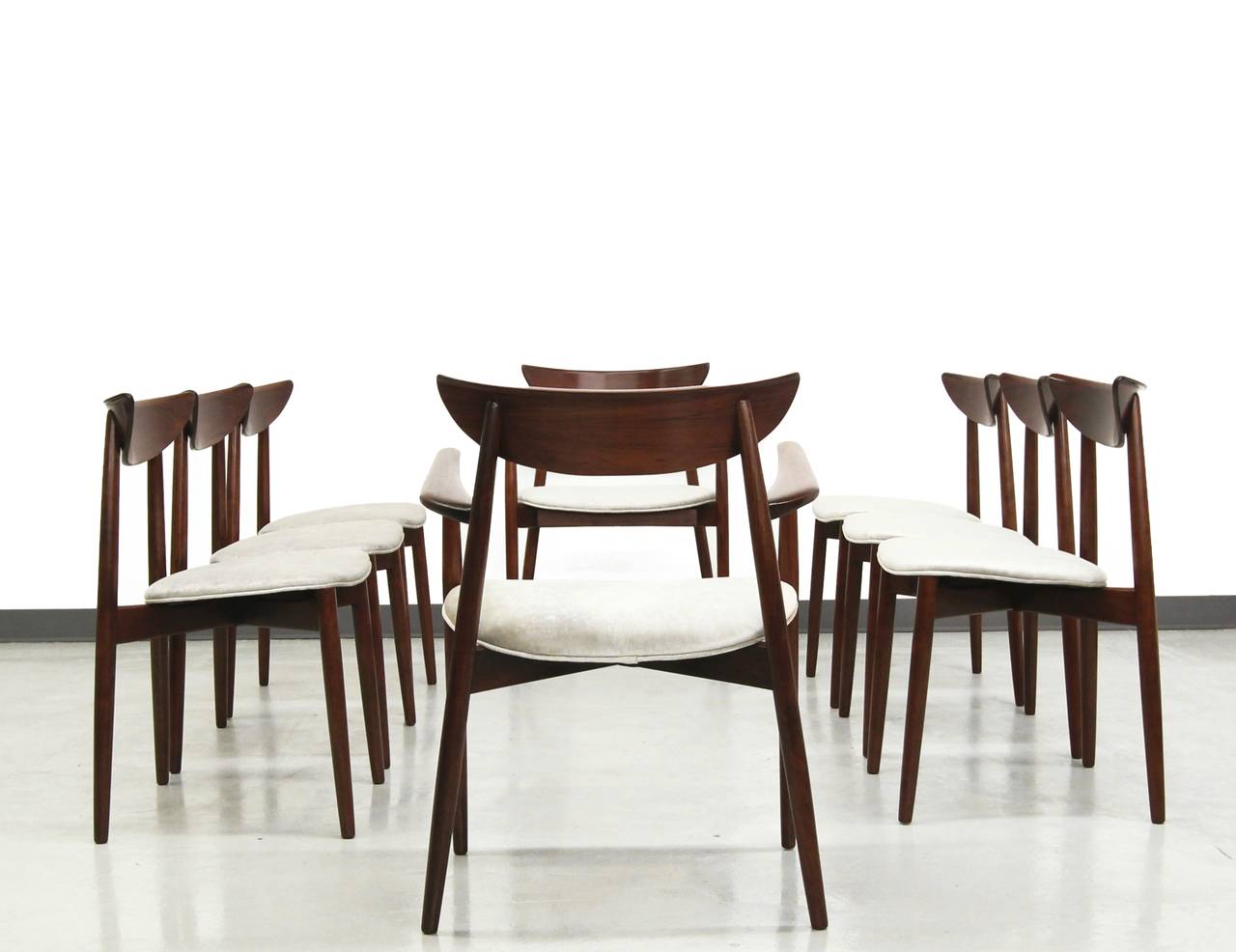 Rare and absolutely gorgeous set of solid rosewood Danish dining chairs by Harry Ostergaard for A/S Randers. This chairs are the epitome of Danish dining chairs. No detail was spared in the making of these beauties with beautifully sculpted line and