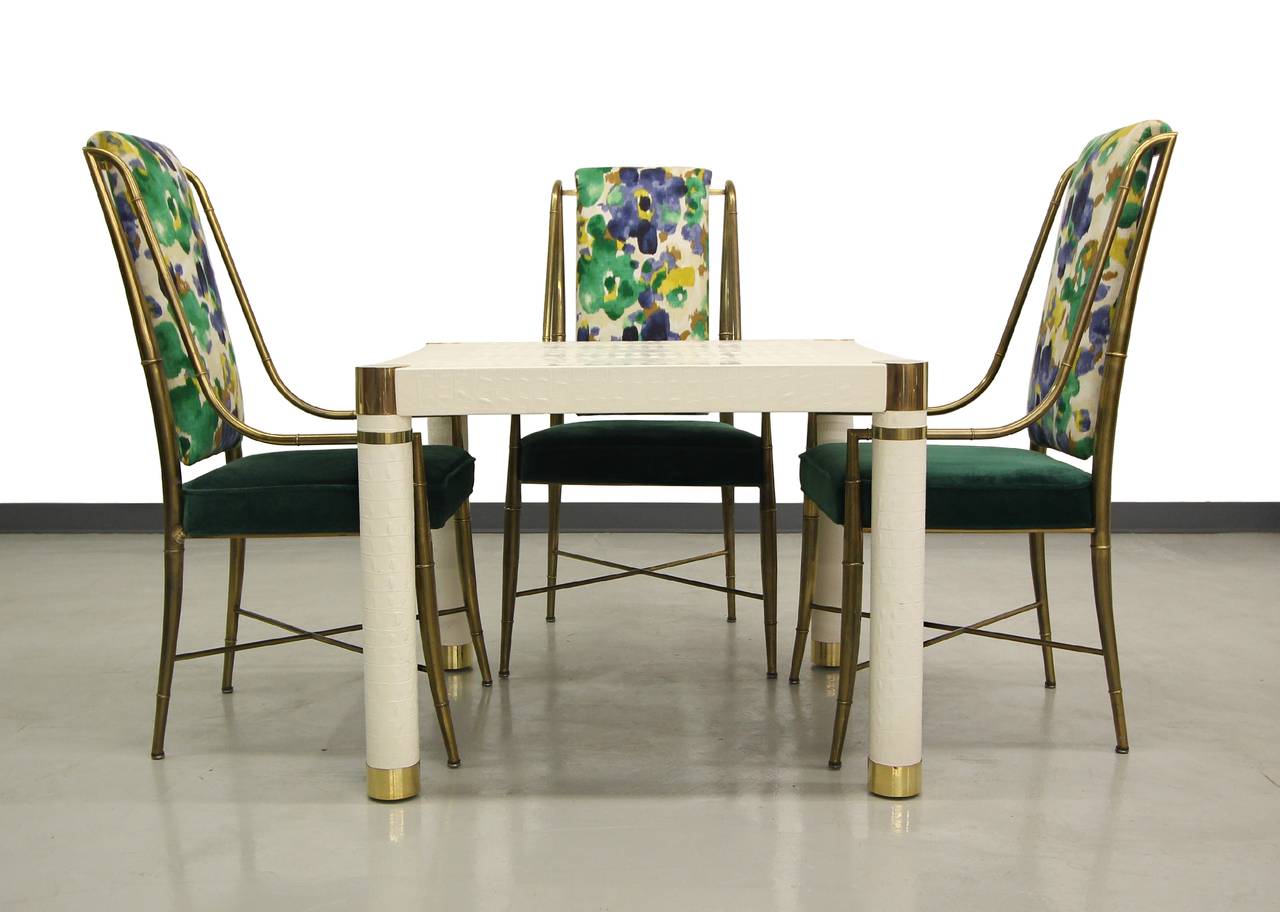 Very elegant and designer crocodile embossed leather square dining card table by Karl Springer. Table is a slightly off white slightly glossy leather with beautiful brass CAP details. Table is simple and perfect for adding a very designer touch to a