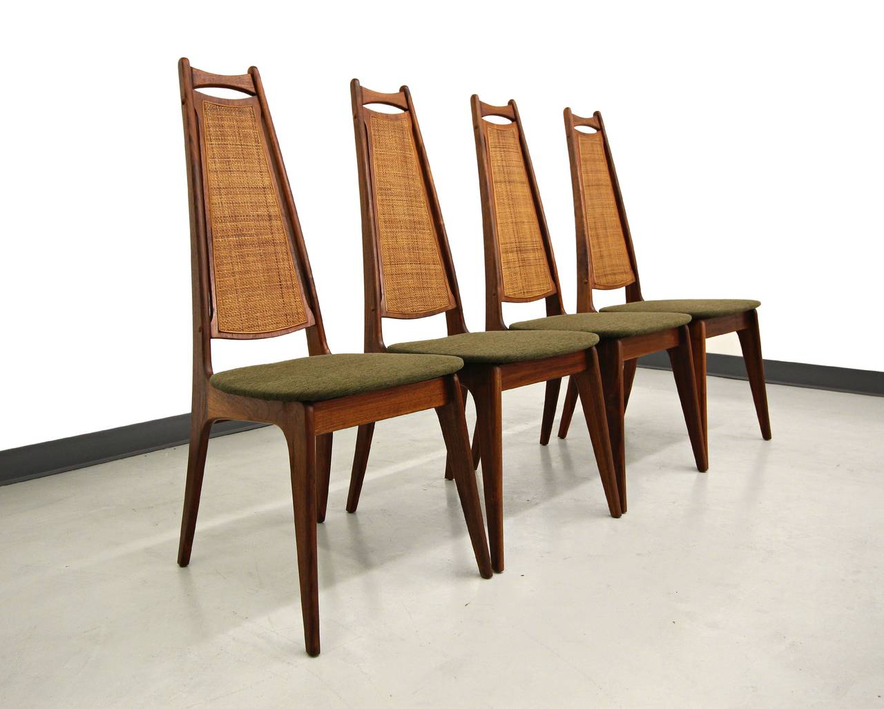 Set of 4 Mid Century Walnut & Cane Dining Chairs Attributed to Adrian Pearsall.  Beautiful sculpted walnut frames with prefect, all original, cane backs.  Chairs have been  reupholstered.