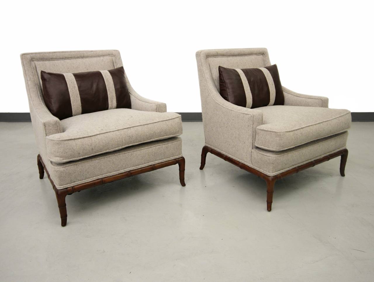 Gorgeous pair of lounge chairs with beautiful sculpted bamboo bases. Perfect, cozy and comfortable in any space. Similar in style to chairs by TH Robsjohn Gibbings for Widdicomb. Chairs have been newly upholstered.