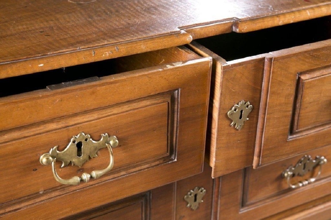 Made circa 1790 or so, this beautiful walnut commode has two short drawers, over two full length drawers. Raised on bun feet, along with some nice carving and impressive hardware, as well as original locks, this Walnut commode is extremely handsome,