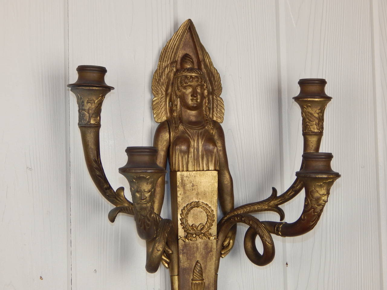 Great pair of Empire Period four light wall sconces. The true Egyptian design of these represent the traditional French Empire style. Design features include a woman at the center with masks and sphinxes on the arms.