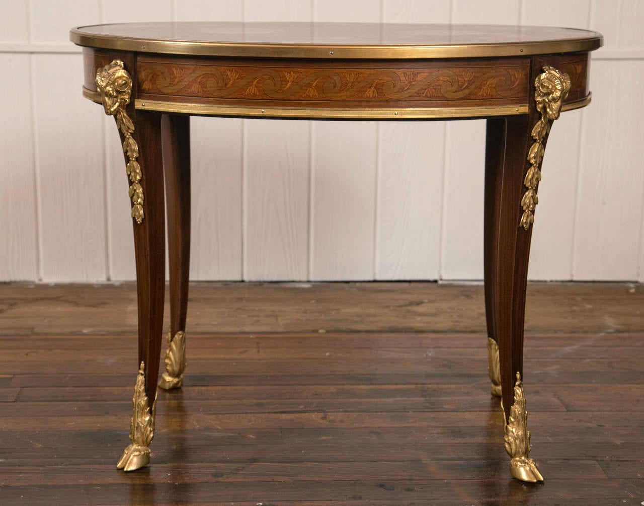 A lovely marquetry inlaid low table, with good bronze mounts, including ram's heads and hoof feet.