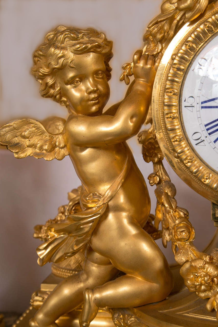 Magnificent three-piece clock set featuring cherubs. The bronze is of excellent quality with incredible detail. It is signed Charpentier & Cie Bronziers, Rue Charlot 8 Paris. The candelabra tops supported by the cherubs still have their original