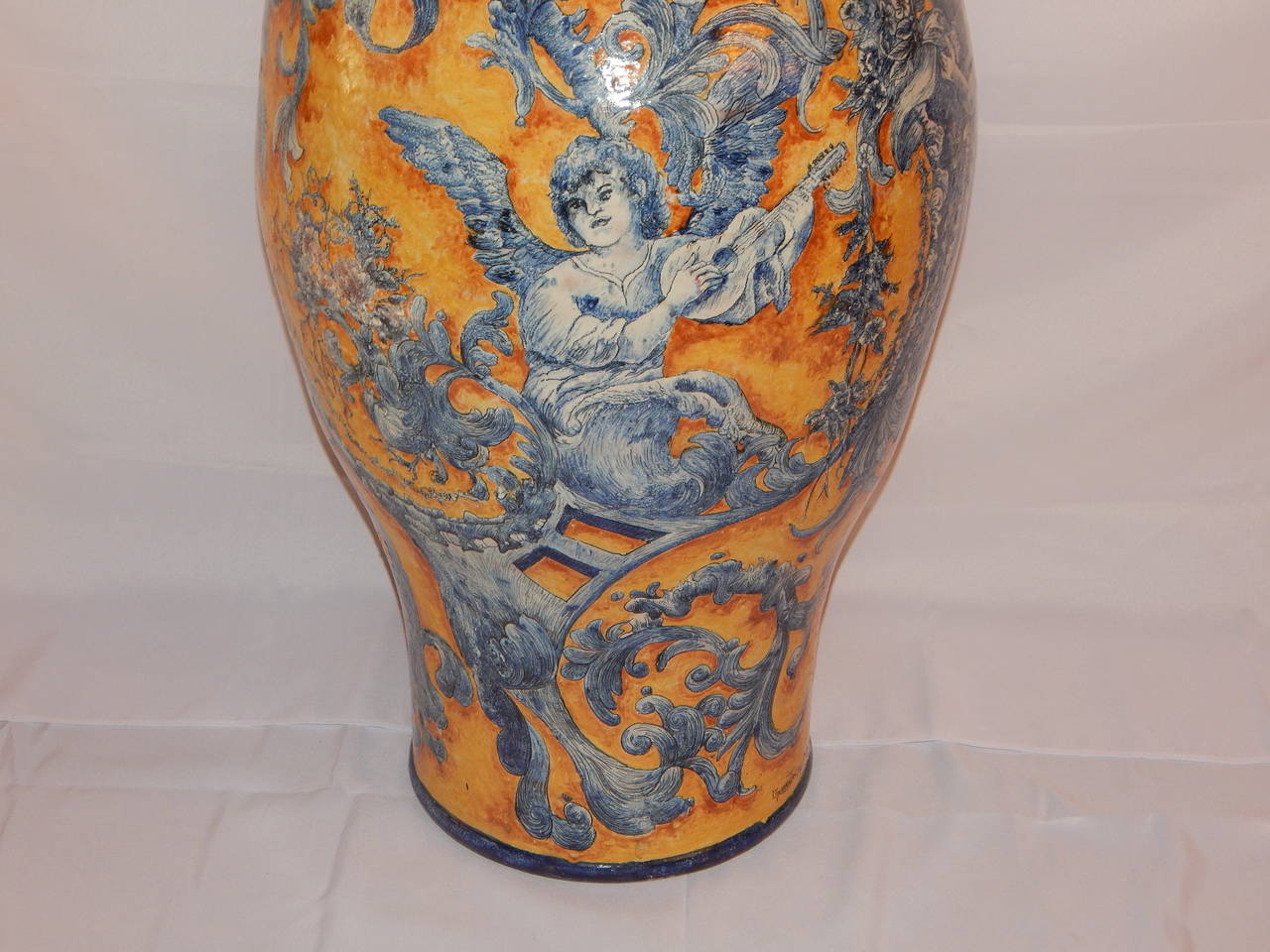 A wonderful large hand-painted faience floor vase, with cover, hand-painted with different cherubs or angels, playing music, signed.