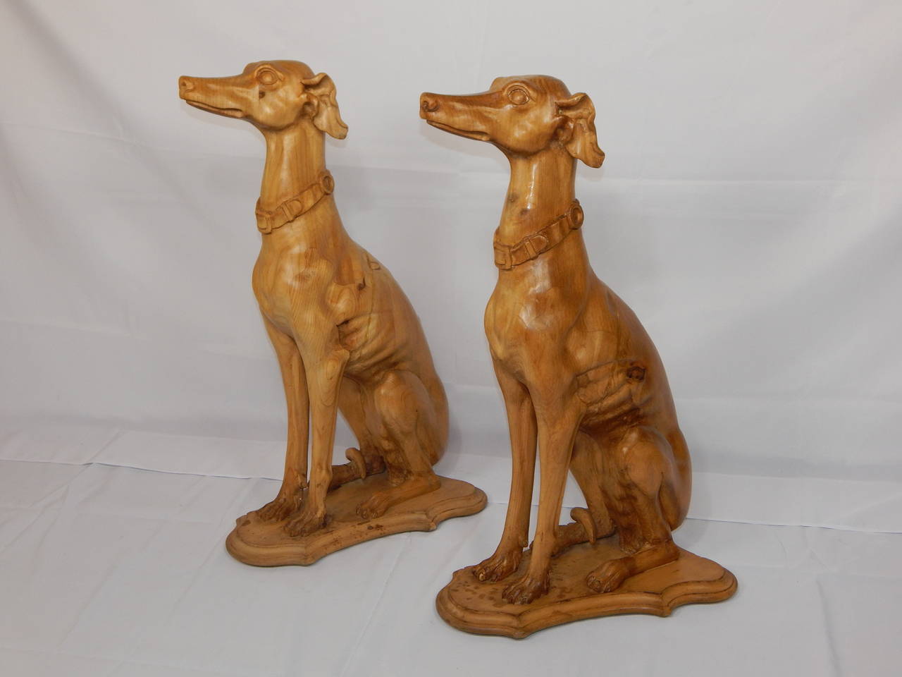 Wonderful and rare set of four of large carved pine whippets or Greyhound dogs, with lovely patina.