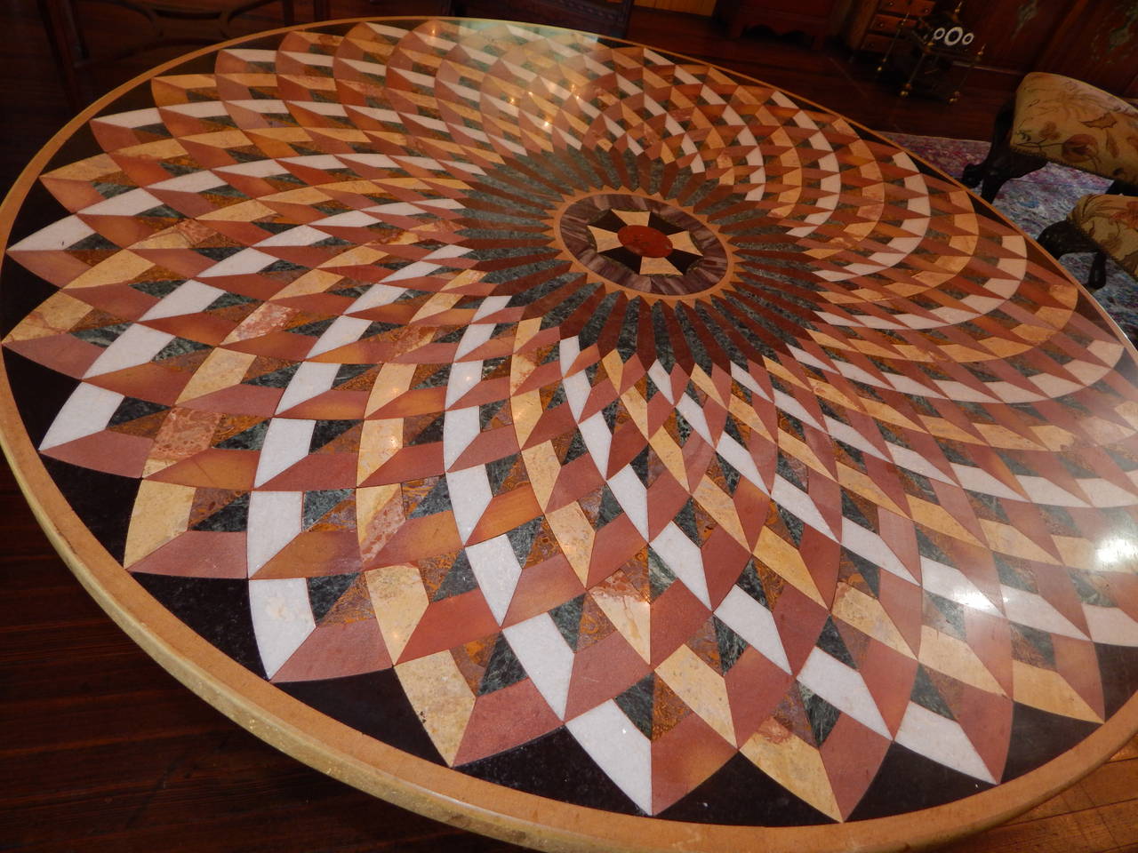 A beautiful Pietra Dura inlaid specimen marble table 48" with an iron and brass base.