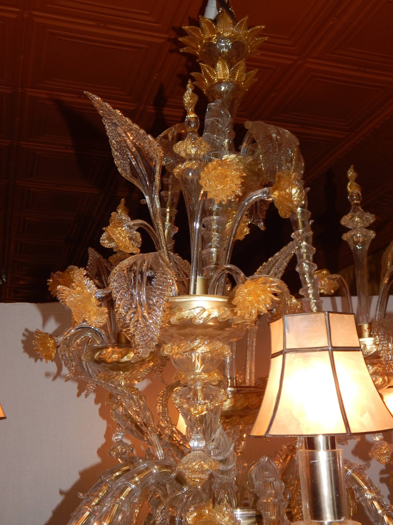 An elaborate Venetian six light chandelier, with clear and gold glass, and six mica shades.