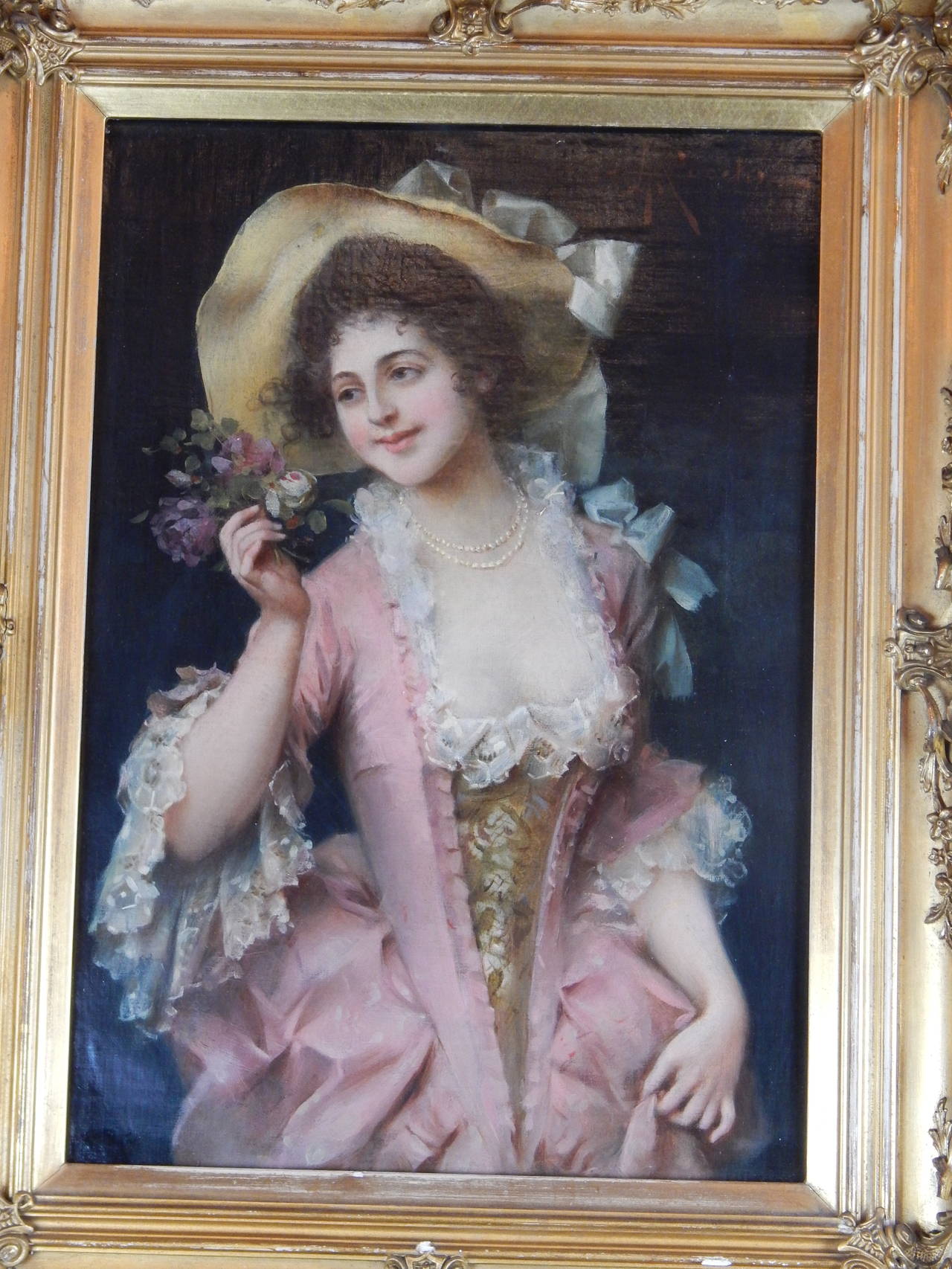 Adriano Cecchi, 1850-1936
A beautifully executed oil on canvas of a pretty woman in a pink dress, holding flowers, Signed A. Cecchi, in a giltwood frame.