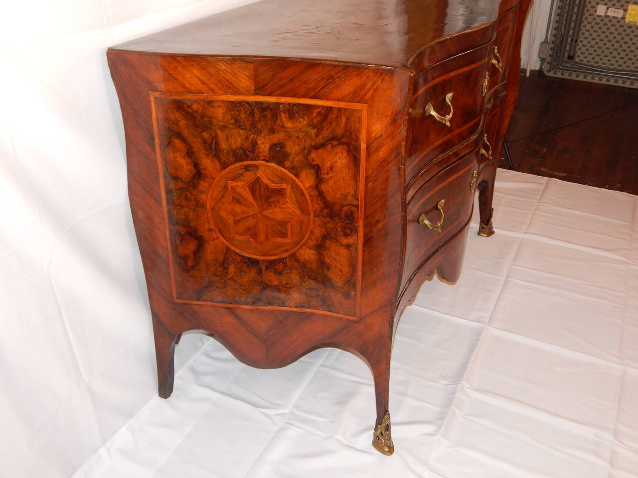 A large serpentine shape two-drawer Italian commode with crossbanding
and inlay.