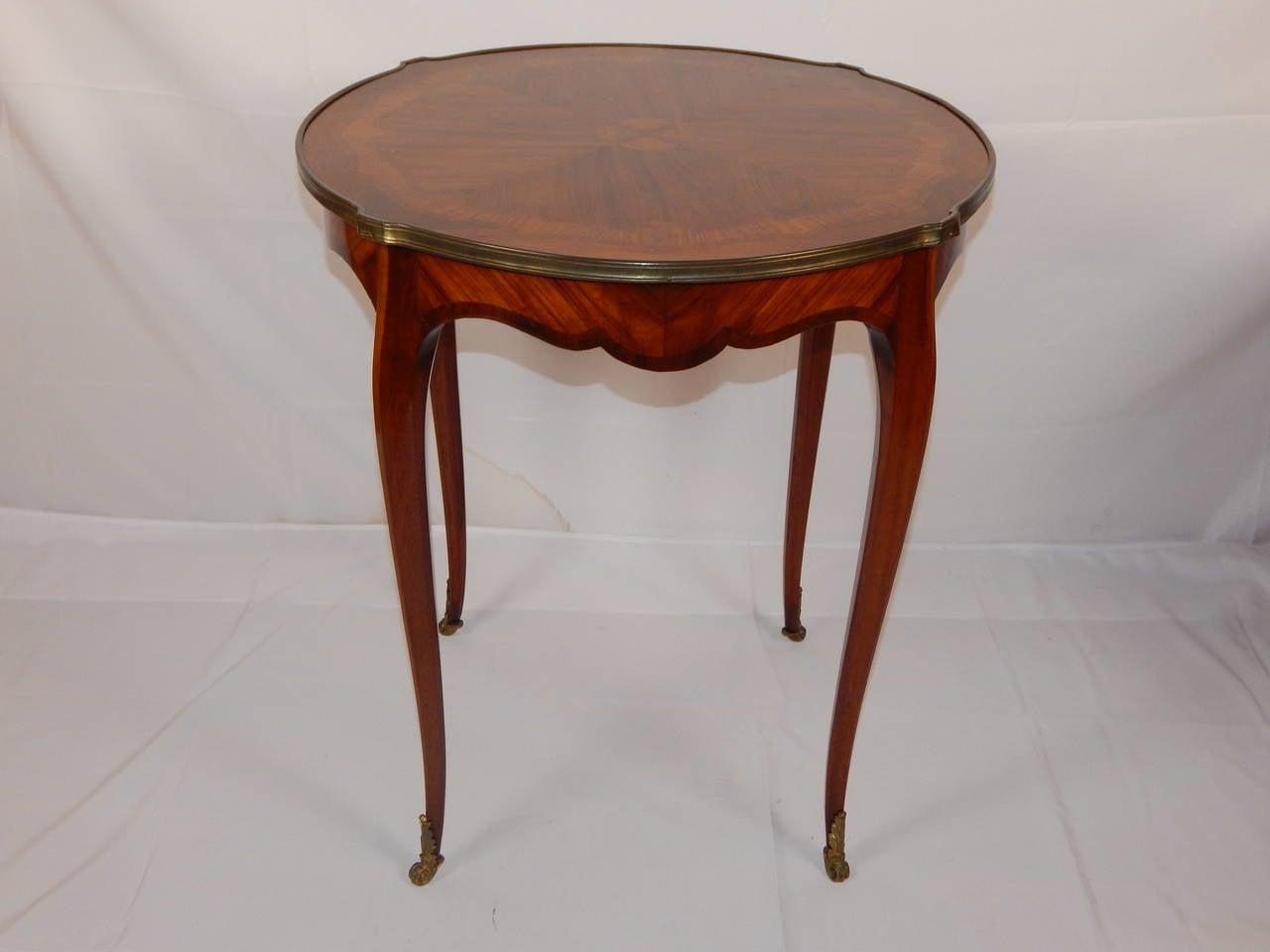 A lovely pair of Louis XV style Rosewood inlaid bouillotte tables, also
known as end or lamp tables, with bronze feet.