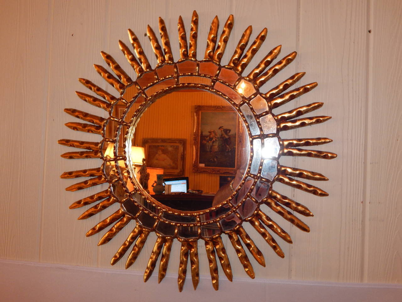 An unusual sunburst form carved gilt wood mirror.