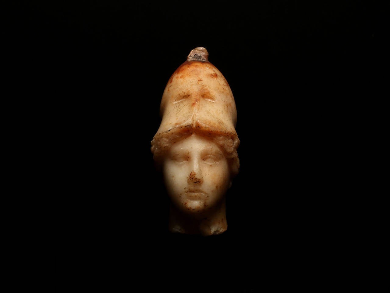 Roman period, 1st-2nd century A.D. 
The goddess with almond shaped lidded eyes, her wavy hair centrally parted, her Corinthian helmet pushed back from her face, a drilled dowel for the now missing crested marble and bronze plumage.

Formerly in