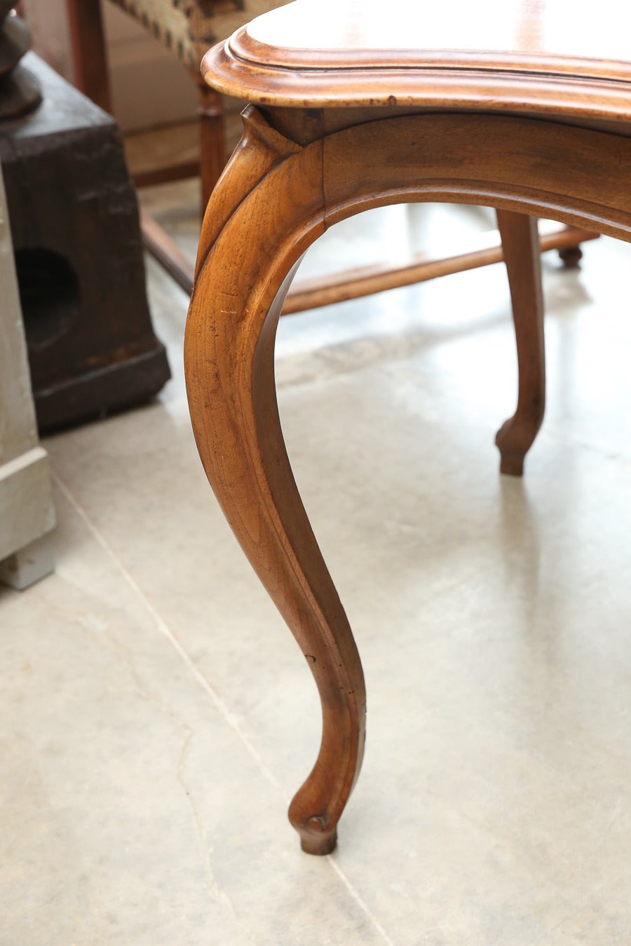 Light walnut writing table or desk with simple carvings with elegant Louis XV style legs.