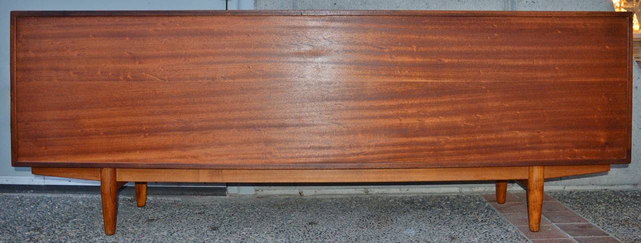 This stellar 1960s quality Danish Modern teak buffet/credenza/sideboard has gorgeous detailing throughout! Made by Dyrlund, with 4 sliders with suit lapel door pulls, 4 adjustable shelves, and a stunning bank of 5 drawers with bowtie drawer fronts,