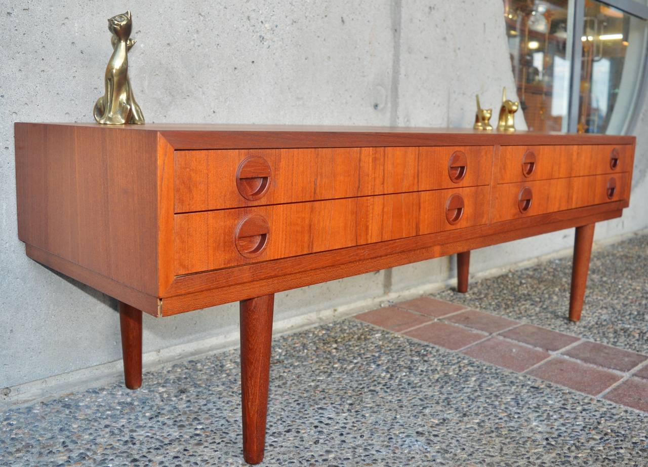 This uniquely sized Danish Modern teak low console table / buffet is the perfect compact size and height for a wide-screen TV stand.  Top quality early construction with all hardwood construction, the drawer frames are made of birch and the the