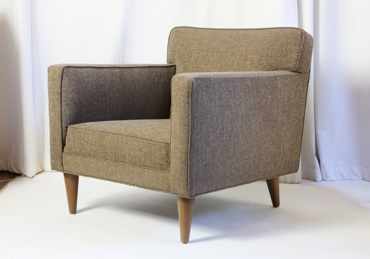 Two Dunbar arm chairs, designed by Edward Wormley (American, 1907-1995), reupholstered in later fabric, rising on tapered legs, not marked.