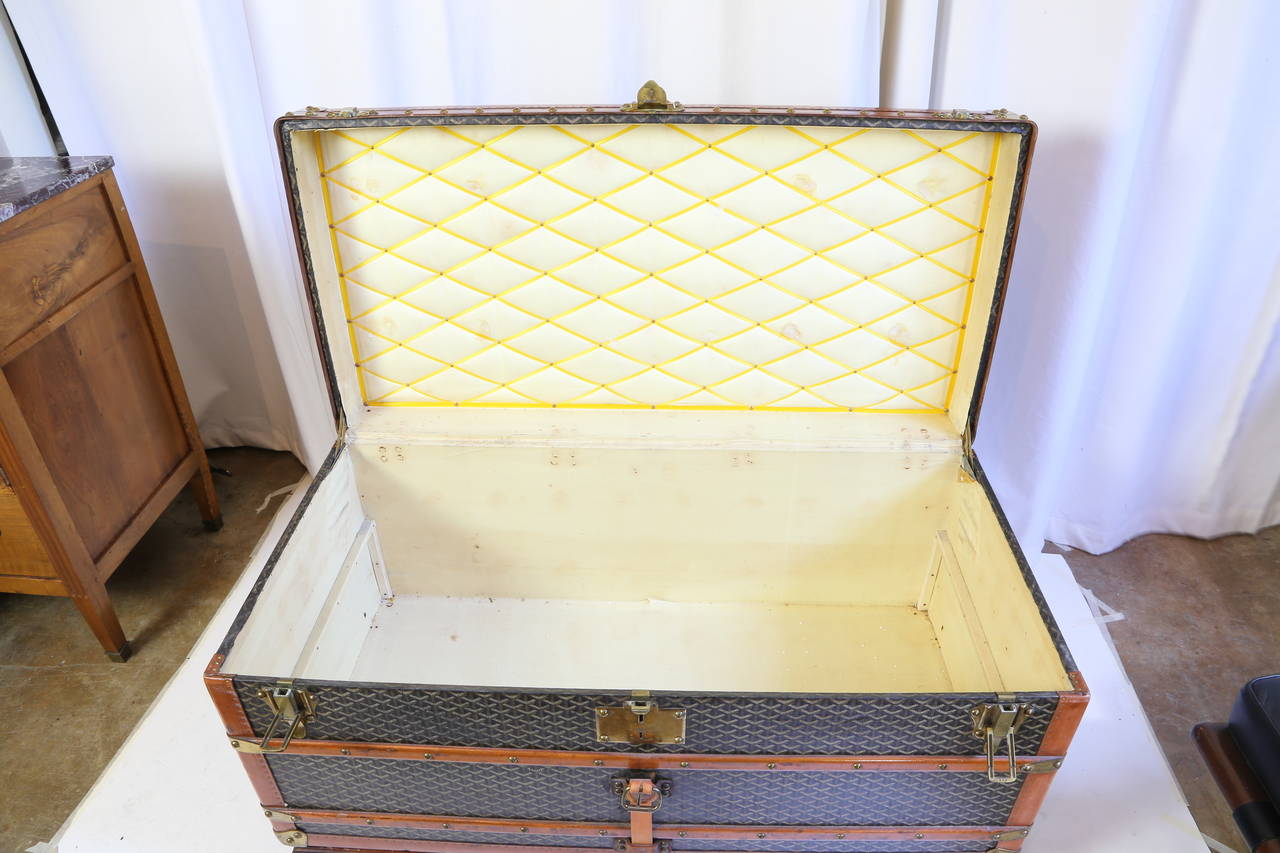 This is a rare and beautiful Goyard steamer trunk from the early 1900's in very nice original condition. The piece features the Goyard signature canvas trimmed with wood and brass and with a leather strap. The trunk has its two original trays.