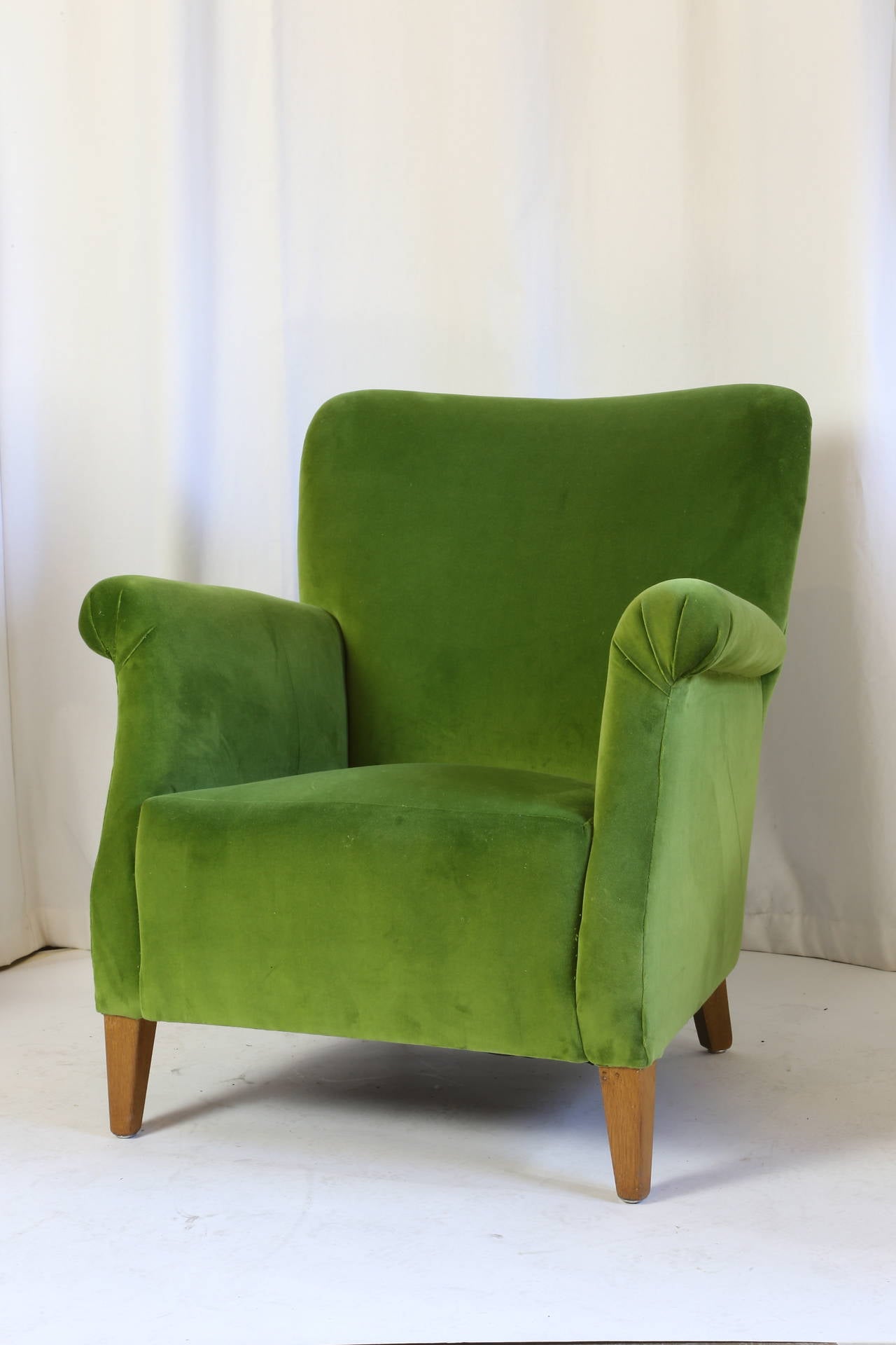 Danish boudoir armchairs newly upholstered in apple green velvet rising on squared angled legs.